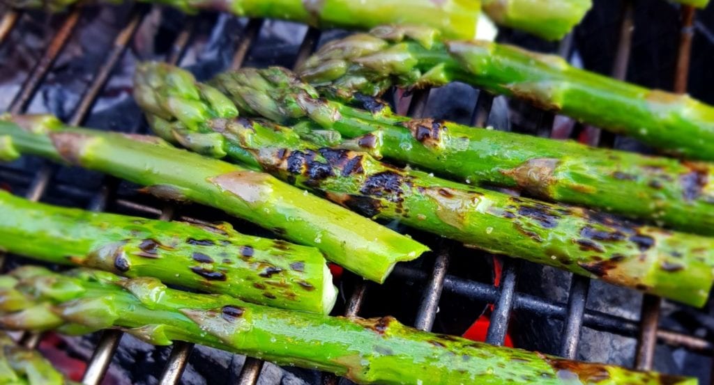 Grilled asparagus on a barbecue