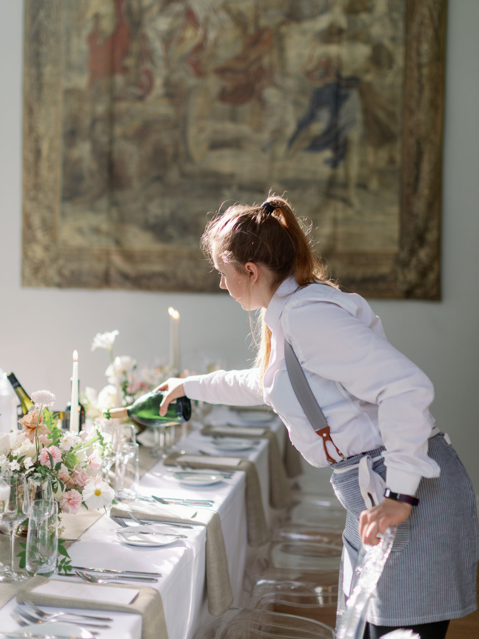 Ross and Ross waitress pouring wine at a wedding