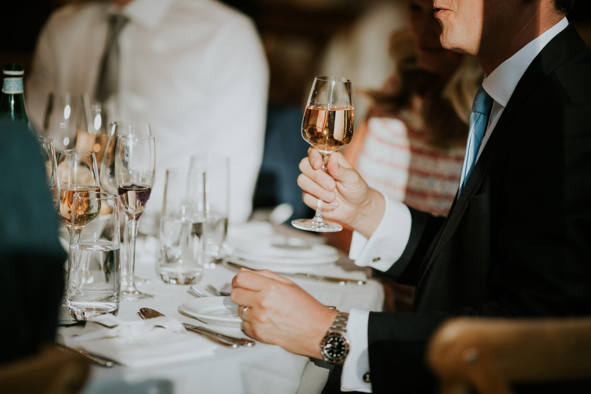 Guest drinking wine at a corporate event dinner