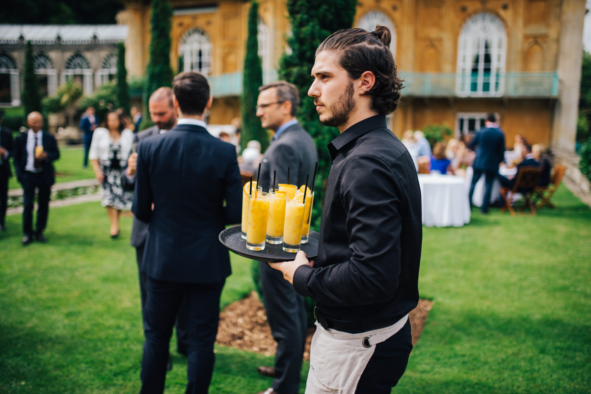 Ross and Ross waiter serving drinks at a private event