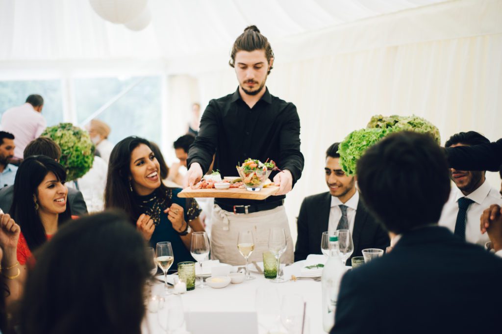 Ross and Ross waiter serving food at a corporate event