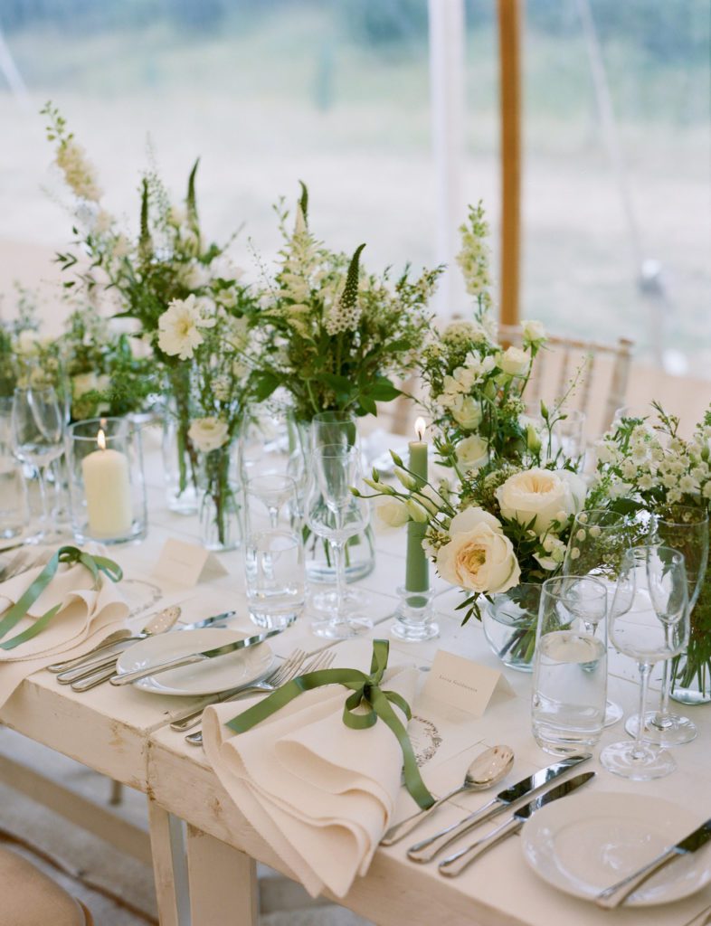 Wedding table dressed with green and white flowers