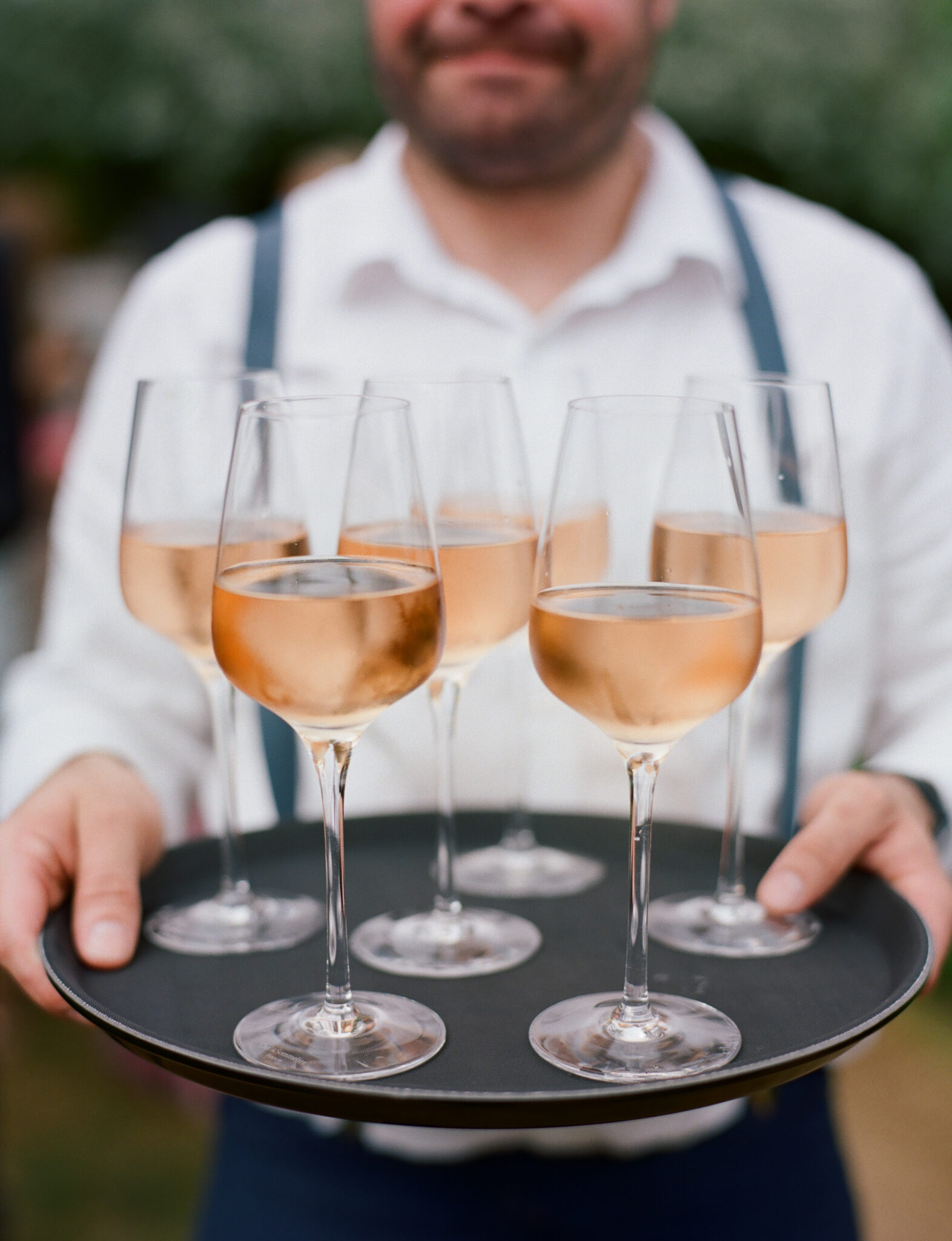 Waiter serving Rosé wine at a marquee wedding